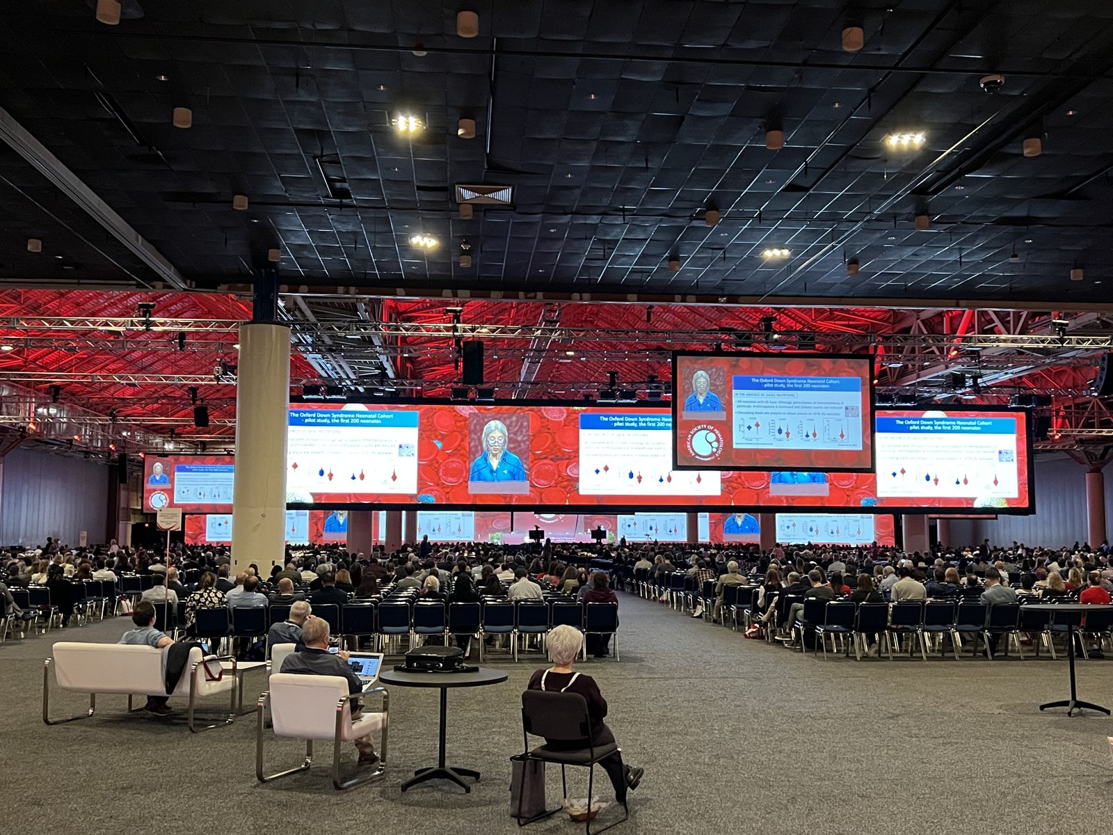 Arena-scale general session with thousands of attendees and multiple screens