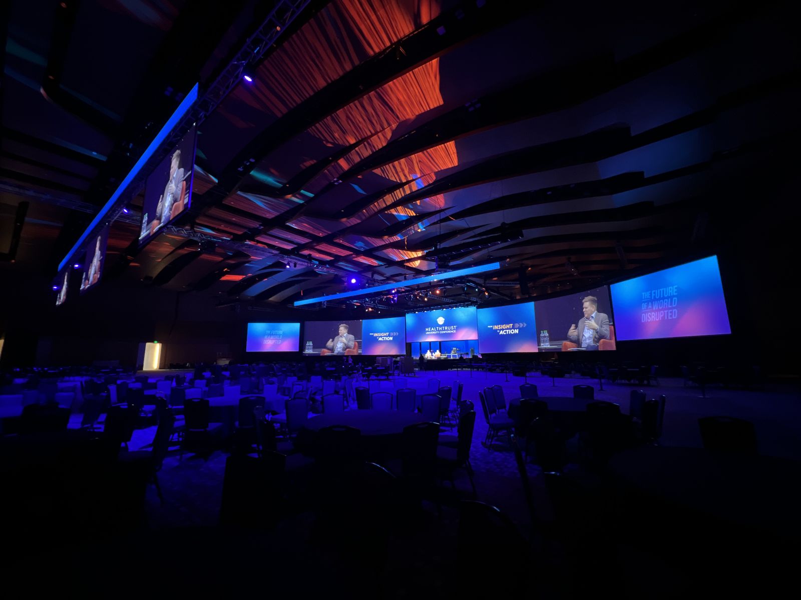 Conference general session with curved LED screens and lighting design